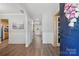 Bright foyer with wood-look floors, white wainscoting, and arched doorways leading to other rooms at 2856 Huckleberry Hill Dr, Fort Mill, SC 29715