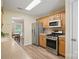 Spacious kitchen with stainless steel appliances, wood cabinets, and plenty of natural light at 2856 Huckleberry Hill Dr, Fort Mill, SC 29715