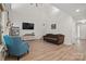 Open living room with wood-look floors, high ceilings, and a staircase leading to the second floor at 2856 Huckleberry Hill Dr, Fort Mill, SC 29715