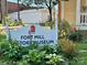 A sign for Fort Mill History Museum surrounded by green plants at 2856 Huckleberry Hill Dr, Fort Mill, SC 29715