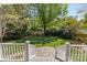 Spacious backyard featuring well-maintained lawn, landscaping, and stone patio at 3019 Sunset Dr, Charlotte, NC 28209