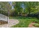 Spacious backyard featuring a stone patio and grass, framed by a wooden fence at 3019 Sunset Dr, Charlotte, NC 28209