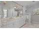 Well-lit bathroom with double sink vanity, decorative mirrors, and white cabinetry, offering a clean aesthetic at 3019 Sunset Dr, Charlotte, NC 28209