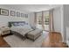 Comfortable bedroom featuring hardwood floors, neutral decor, a cozy rug and windows with natural light at 3019 Sunset Dr, Charlotte, NC 28209