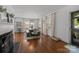 Bright dining room featuring hardwood floors, elegant lighting, and multiple windows for ample natural light at 3019 Sunset Dr, Charlotte, NC 28209