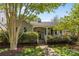Charming single story home boasts a covered porch with well-manicured shrubs and trees in a lovely landscaped yard at 3019 Sunset Dr, Charlotte, NC 28209