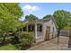 Exterior view of charming home featuring a black metal gate, lawn, and side porch at 3019 Sunset Dr, Charlotte, NC 28209