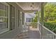 Inviting front porch with brick flooring, shutters, and rocking chairs at 3019 Sunset Dr, Charlotte, NC 28209