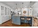 Bright eat-in kitchen with white cabinetry, stainless steel appliances, kitchen island, and hardwood floors at 3019 Sunset Dr, Charlotte, NC 28209