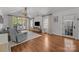 Neutral living room offers hardwood floors, natural light and a vaulted ceiling with a decorative chandelier at 3019 Sunset Dr, Charlotte, NC 28209
