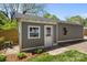 Charming outbuilding with concrete siding and classic white trim and door at 3019 Sunset Dr, Charlotte, NC 28209