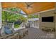 Relax on this covered patio with a ceiling fan, outdoor furniture, and scenic backyard views at 3019 Sunset Dr, Charlotte, NC 28209