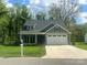 Charming home featuring a two-car garage, well-manicured lawn, and a welcoming front porch perfect for relaxing at 3128 Harmon Homestead Rd, Shelby, NC 28150