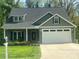 Inviting home with a two-car garage, cozy front porch, and lovely landscaping that enhances curb appeal at 3128 Harmon Homestead Rd, Shelby, NC 28150