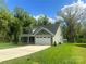 Beautiful home showcasing a spacious driveway, lush lawn, and appealing exterior with a well-maintained yard at 3128 Harmon Homestead Rd, Shelby, NC 28150