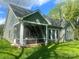 Backyard screened porch, ideal for outdoor lounging and entertainment, with comfortable seating area and ceiling fan at 3128 Harmon Homestead Rd, Shelby, NC 28150