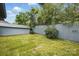 A backyard enclosed with a wooden fence, featuring lush green grass, and a utility shed at 313 Mayflower Ave, Cramerton, NC 28032