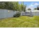 Well-maintained backyard featuring lush green grass and a privacy fence with an elevated deck at 313 Mayflower Ave, Cramerton, NC 28032
