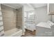 Updated bathroom features a tiled shower and modern vanity with granite countertop, plus washer and dryer hookups at 313 Mayflower Ave, Cramerton, NC 28032