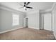 Neutral bedroom with ceiling fan, carpeted floors, and multiple closets at 313 Mayflower Ave, Cramerton, NC 28032