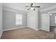 Spacious bedroom with neutral walls, carpet, a ceiling fan, window and a closet at 313 Mayflower Ave, Cramerton, NC 28032