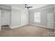 Spacious bedroom featuring carpeted floor, ceiling fan, and ample closet space at 313 Mayflower Ave, Cramerton, NC 28032