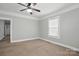 Bedroom featuring neutral colored walls, carpet, ceiling fan, and a large window for ample natural light at 313 Mayflower Ave, Cramerton, NC 28032