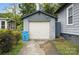 Detached garage with concrete block construction and a white door; includes a blue trash receptacle at 313 Mayflower Ave, Cramerton, NC 28032