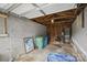 The garage with concrete walls, wooden supports, open ceiling and miscellaneous items at 313 Mayflower Ave, Cramerton, NC 28032