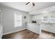 Eat-in kitchen featuring bright white cabinetry and bar counter at 313 Mayflower Ave, Cramerton, NC 28032