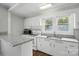 Updated kitchen with stainless steel appliances, granite countertops, and bright natural lighting at 313 Mayflower Ave, Cramerton, NC 28032