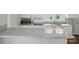 Bright kitchen featuring granite countertop, stainless steel sink, and modern appliances at 313 Mayflower Ave, Cramerton, NC 28032