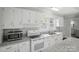 Well-lit kitchen with stainless steel appliances, granite countertops, and ample white cabinets at 313 Mayflower Ave, Cramerton, NC 28032