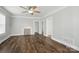 Inviting living room with hardwood floors, ceiling fan and painted fireplace at 313 Mayflower Ave, Cramerton, NC 28032