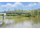 Picturesque water view featuring a walking bridge and lush greenery, offering scenic tranquility and recreation at 313 Mayflower Ave, Cramerton, NC 28032
