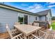 Back deck showcasing outdoor seating, a grill, a wood railing, and the home's light blue siding at 3659 Kimber Ln, Sherrills Ford, NC 28673