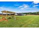 Backyard featuring a swing set and lawn, wood fencing and a view of the home's light blue siding at 3659 Kimber Ln, Sherrills Ford, NC 28673