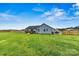 Backyard showcasing a lush lawn, a wood fence, the home's light blue siding and back deck at 3659 Kimber Ln, Sherrills Ford, NC 28673