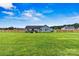 Backyard showcasing a lush lawn, a wood fence, the home's light blue siding and back deck at 3659 Kimber Ln, Sherrills Ford, NC 28673