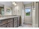 Bathroom featuring a double sink vanity with granite countertops, wood cabinets, and light gray flooring at 3659 Kimber Ln, Sherrills Ford, NC 28673