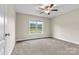 Bedroom featuring neutral-colored walls, carpet, ceiling fan, and a window with a view of the outdoors at 3659 Kimber Ln, Sherrills Ford, NC 28673