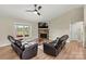 Bright living area with a stone fireplace, wood floors, and a ceiling fan at 3659 Kimber Ln, Sherrills Ford, NC 28673