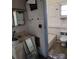 A bathroom with white tile, a toilet, and a small window above the bathtub at 40 Ranlo Ave, Gastonia, NC 28054