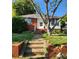 Exterior front yard of brick and white house, showing stairs and manicured lawn at 40 Ranlo Ave, Gastonia, NC 28054