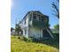 Shot of old house with broken windows, overgrown with vines and vegetation at 40 Ranlo Ave, Gastonia, NC 28054