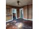 Living room showcasing hardwood floors, wood-paneled walls, and open doorways at 40 Ranlo Ave, Gastonia, NC 28054