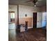 A living room with floral wallpaper and hardwood floors offers a view into another room at 40 Ranlo Ave, Gastonia, NC 28054