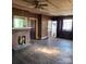 Spacious living room with a brick fireplace, wood floors, and multiple doorways at 40 Ranlo Ave, Gastonia, NC 28054