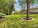 Expansive backyard features a well-maintained lawn, mature trees, and wooden fencing for privacy at 402 Sidney Johnson St, Fort Mill, SC 29715