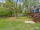 Spacious backyard with a wooden deck, mature trees, and wooden fence at 402 Sidney Johnson St, Fort Mill, SC 29715